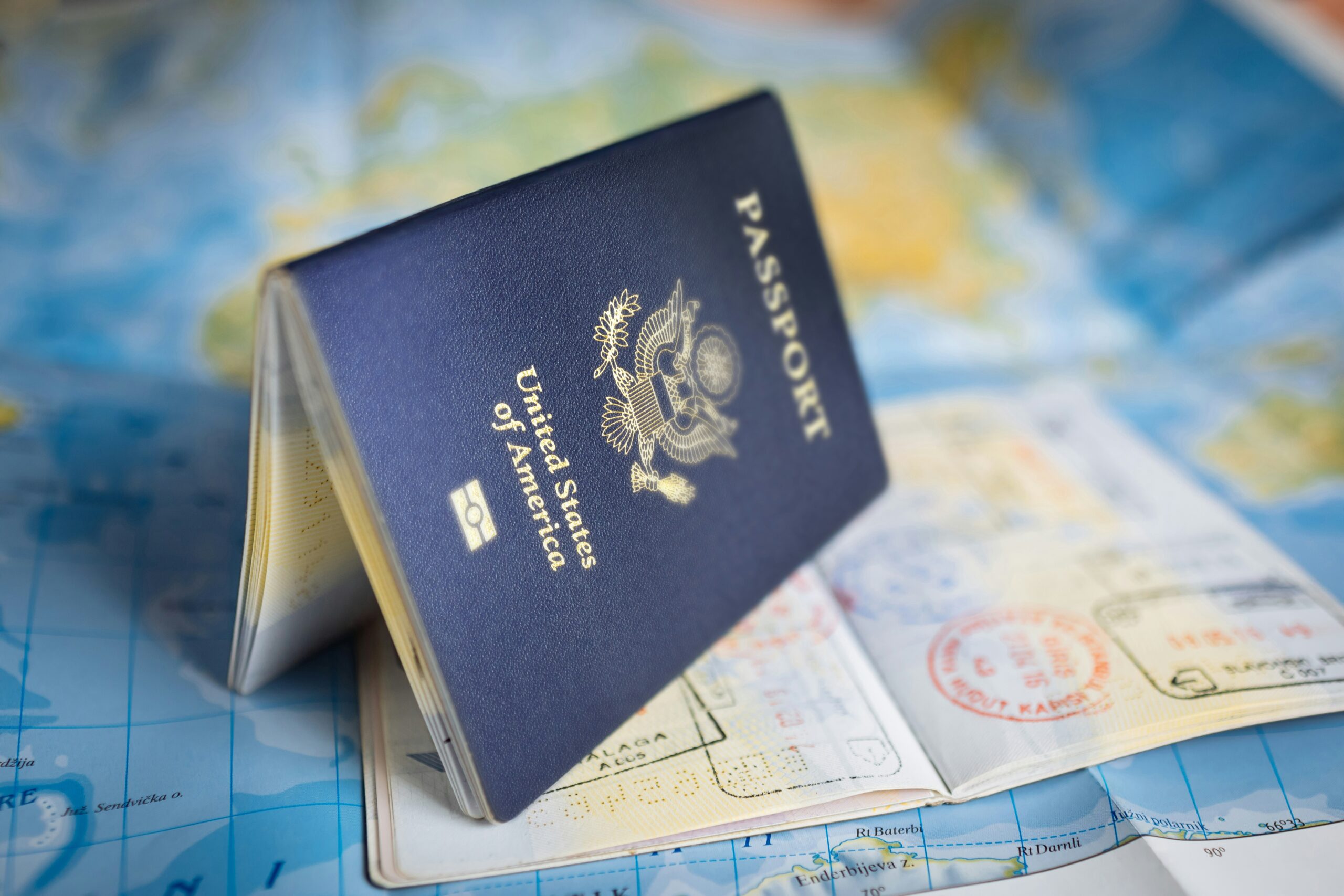 U.S. passport book with application forms on a desk